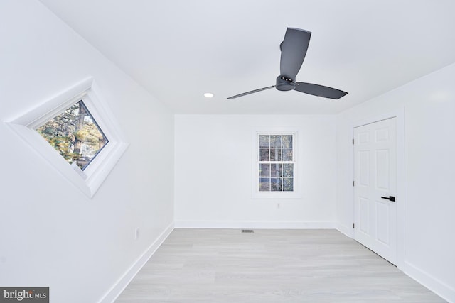 bonus room with ceiling fan, light wood-type flooring, and a skylight