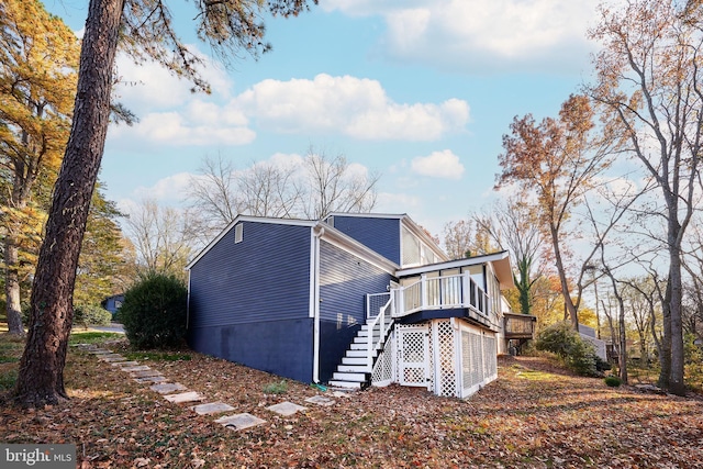 view of side of home with a wooden deck