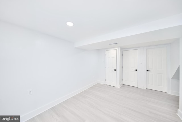 basement with light hardwood / wood-style floors