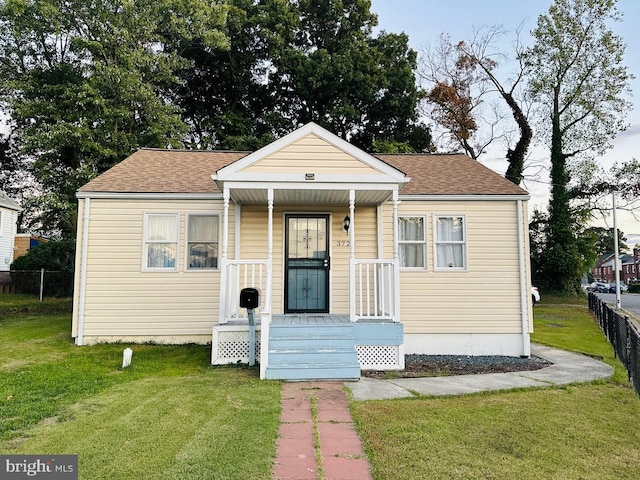 bungalow-style home with a porch and a front yard