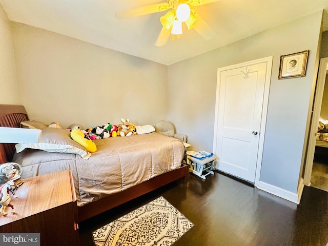 bedroom featuring ceiling fan and dark wood-type flooring