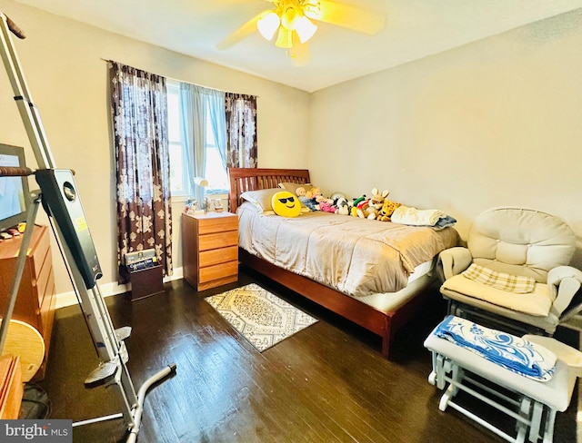 bedroom featuring ceiling fan and dark wood-type flooring