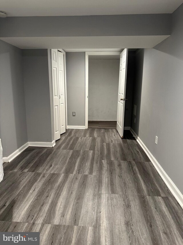 basement with dark wood-type flooring