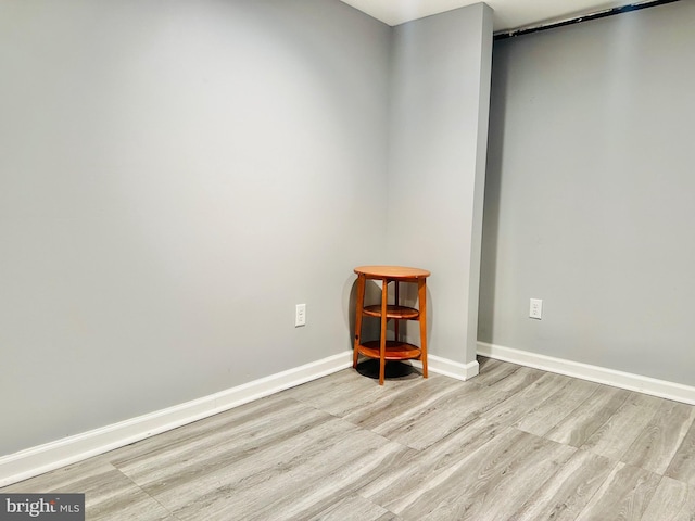 unfurnished room with light wood-type flooring