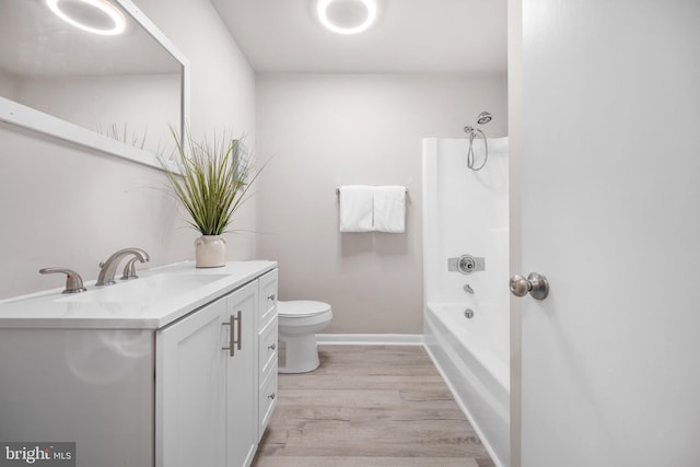 full bathroom with shower / tub combination, hardwood / wood-style floors, vanity, and toilet