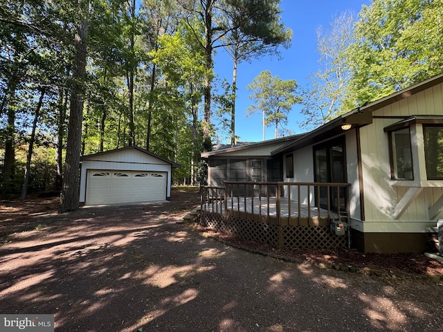 view of yard featuring an outbuilding, a wooden deck, and a garage