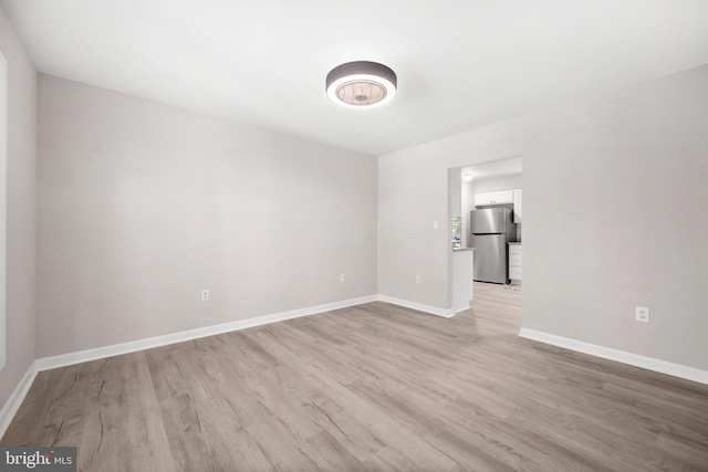 spare room featuring light hardwood / wood-style floors