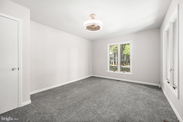 unfurnished bedroom with dark carpet