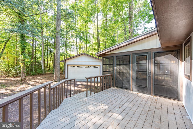 wooden deck with a sunroom and a garage