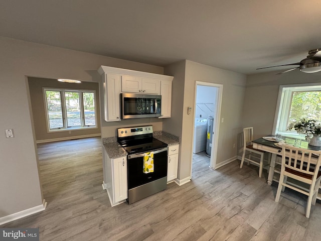 kitchen with light hardwood / wood-style floors, ceiling fan, white cabinetry, and stainless steel appliances