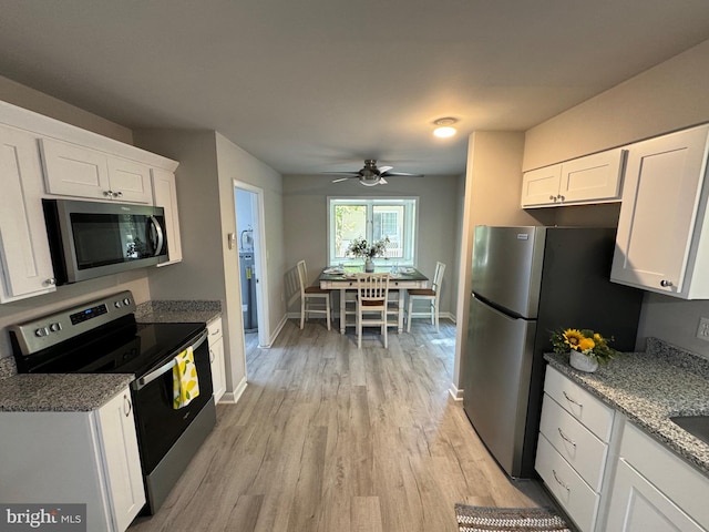 kitchen with ceiling fan, white cabinets, stainless steel appliances, and light wood-type flooring