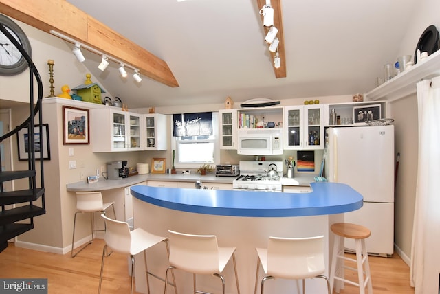 kitchen with light wood-type flooring, a breakfast bar, white cabinets, white appliances, and vaulted ceiling with beams