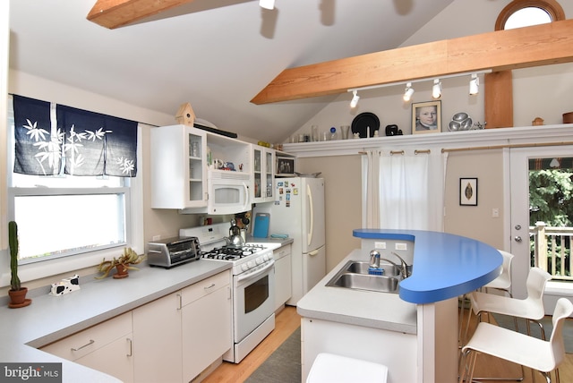 kitchen featuring vaulted ceiling with beams, sink, white appliances, light hardwood / wood-style flooring, and white cabinetry