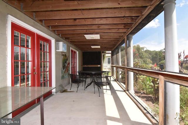 view of patio featuring a wall mounted air conditioner and french doors