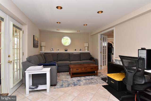 living room featuring french doors and light tile patterned floors