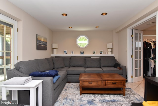 living room with light tile patterned flooring and a healthy amount of sunlight