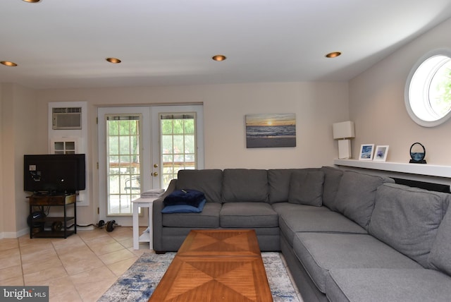 tiled living room featuring french doors and a wall unit AC