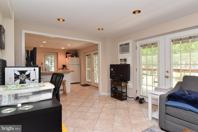 living room featuring light tile patterned flooring, sink, a wall mounted air conditioner, and french doors