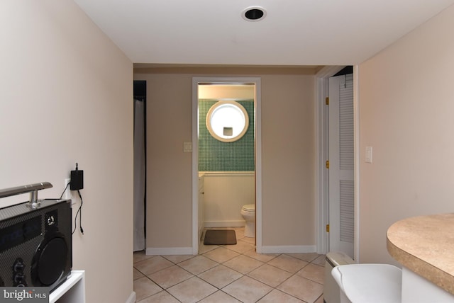 bathroom with tile patterned flooring and toilet