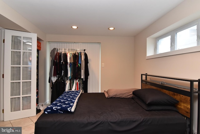 bedroom featuring a closet and light tile patterned floors