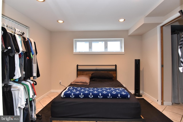 tiled bedroom with a closet