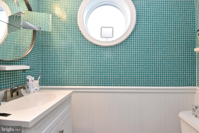 bathroom featuring vanity and toilet