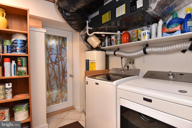 laundry room featuring light tile patterned flooring, washing machine and dryer, and water heater