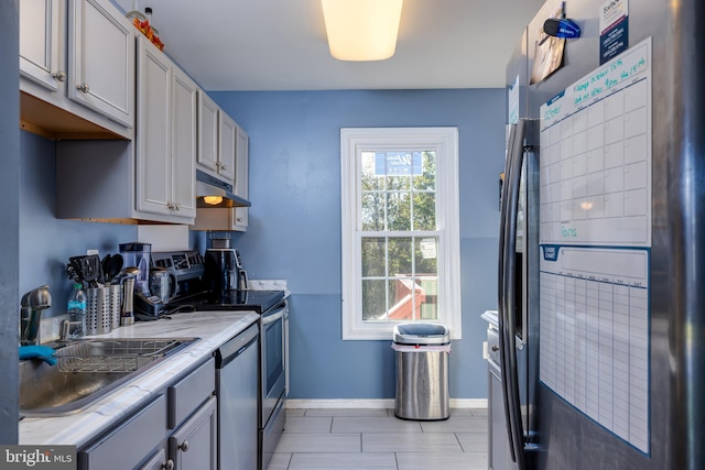 kitchen featuring gray cabinets, sink, and stainless steel appliances