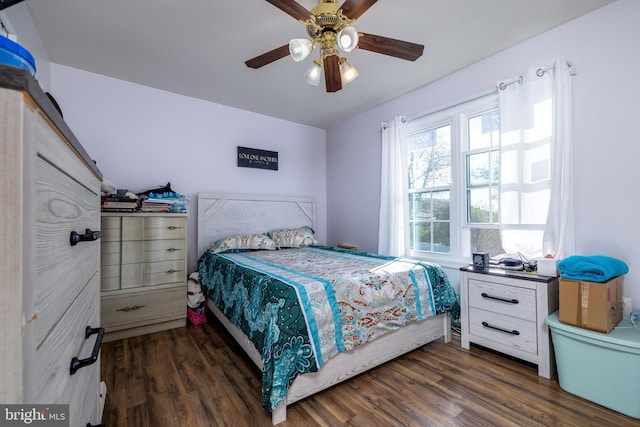 bedroom with dark hardwood / wood-style floors and ceiling fan