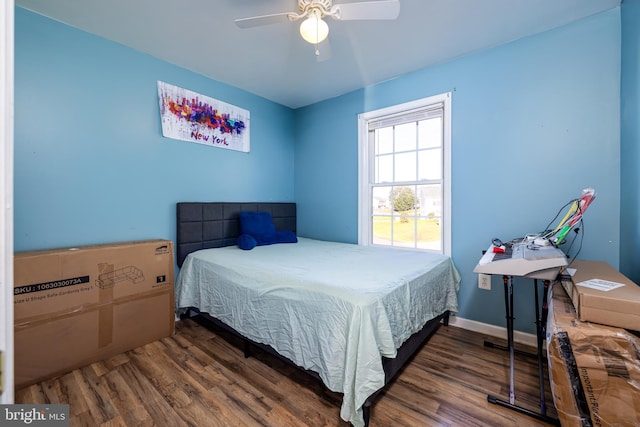 bedroom featuring dark wood-type flooring and ceiling fan