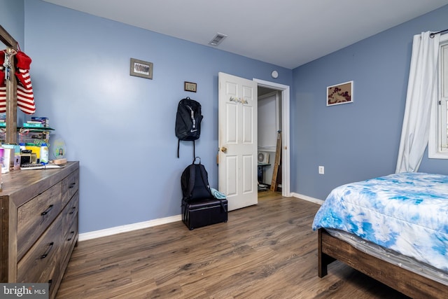 bedroom with dark hardwood / wood-style flooring