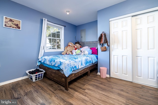 bedroom with a closet and dark hardwood / wood-style flooring