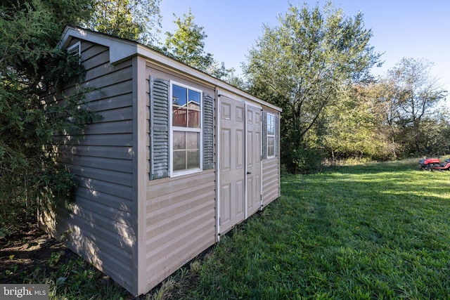 view of outbuilding featuring a lawn