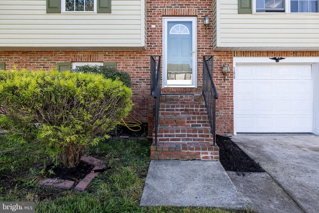 doorway to property with a garage