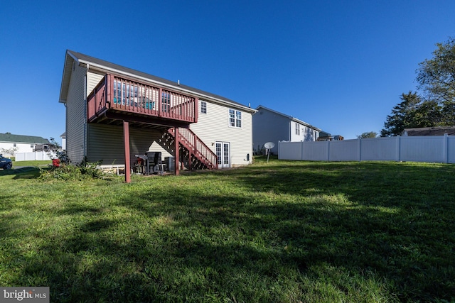 back of property with a yard and a deck