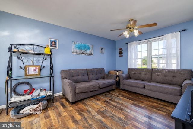 living room with ceiling fan and dark hardwood / wood-style floors