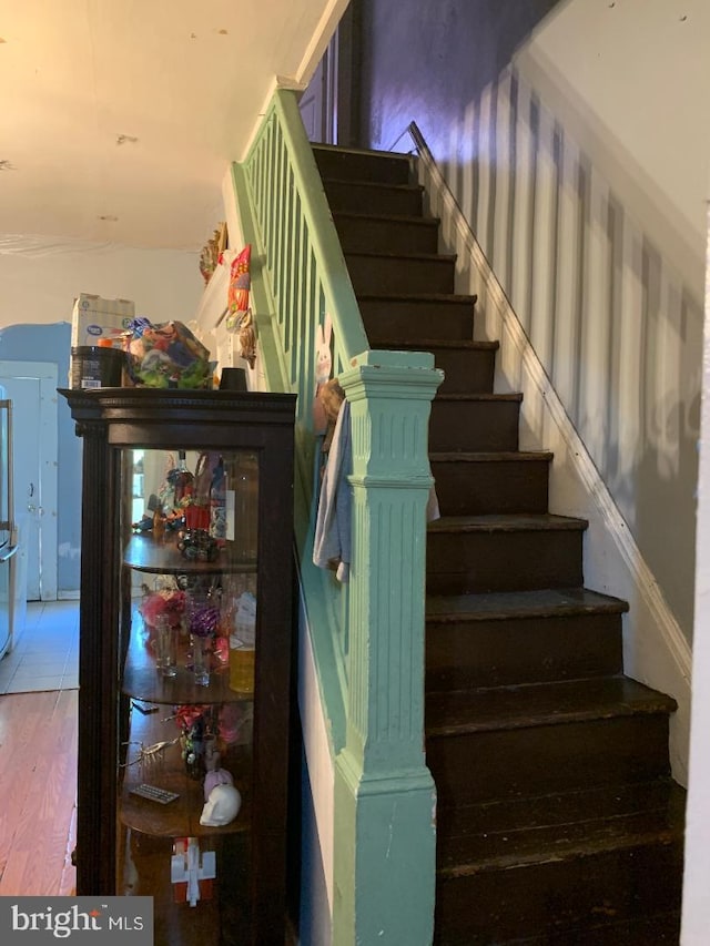 staircase featuring hardwood / wood-style flooring