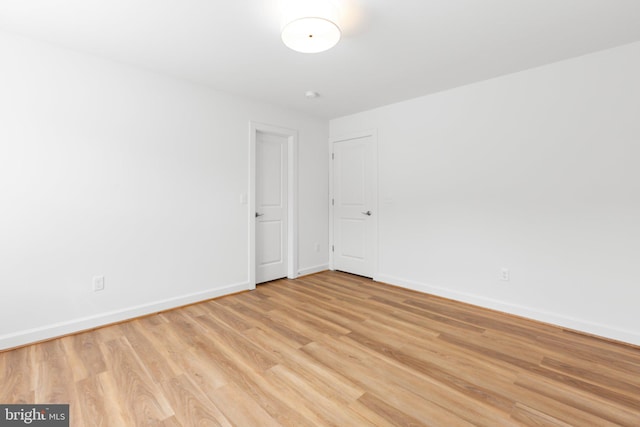 spare room featuring light hardwood / wood-style flooring