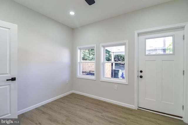 foyer entrance featuring recessed lighting, light wood finished floors, and baseboards
