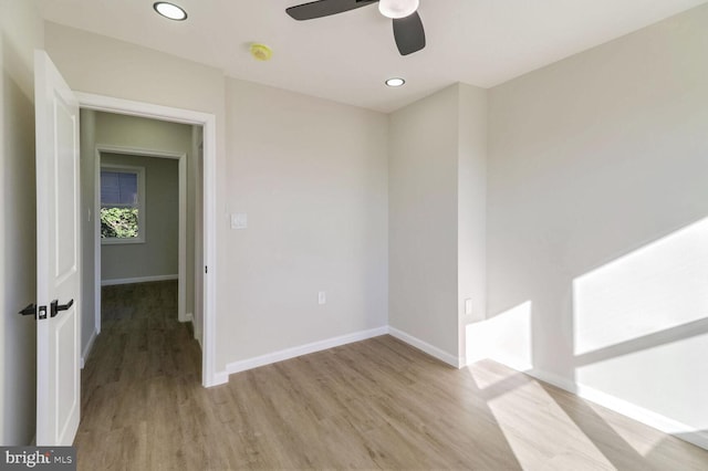 spare room featuring ceiling fan, light wood finished floors, baseboards, and recessed lighting