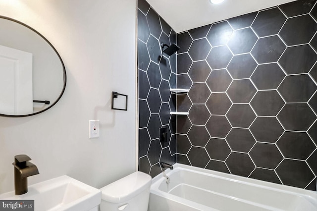 bathroom with a sink, toilet, and shower / bath combination