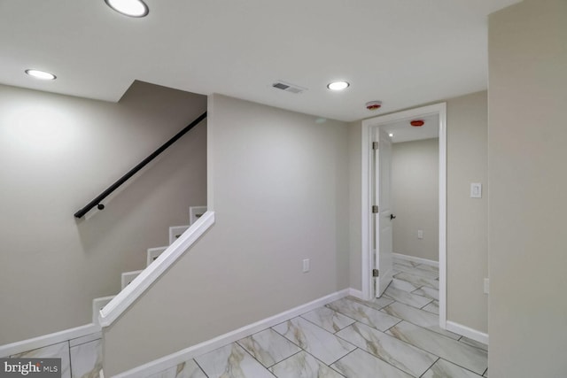 stairs with visible vents, baseboards, recessed lighting, and marble finish floor