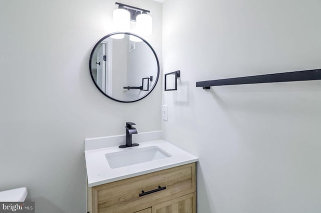 bathroom with toilet and vanity