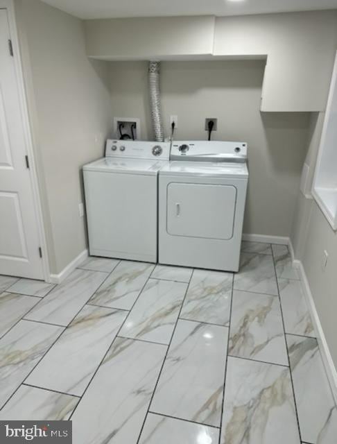 laundry room with laundry area, separate washer and dryer, marble finish floor, and baseboards