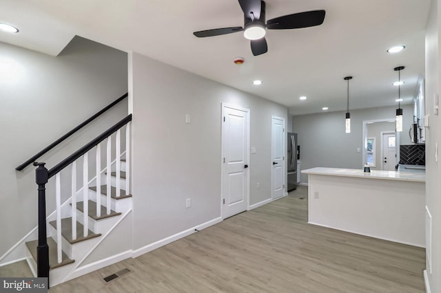 kitchen featuring freestanding refrigerator, light wood-type flooring, a ceiling fan, visible vents, and recessed lighting