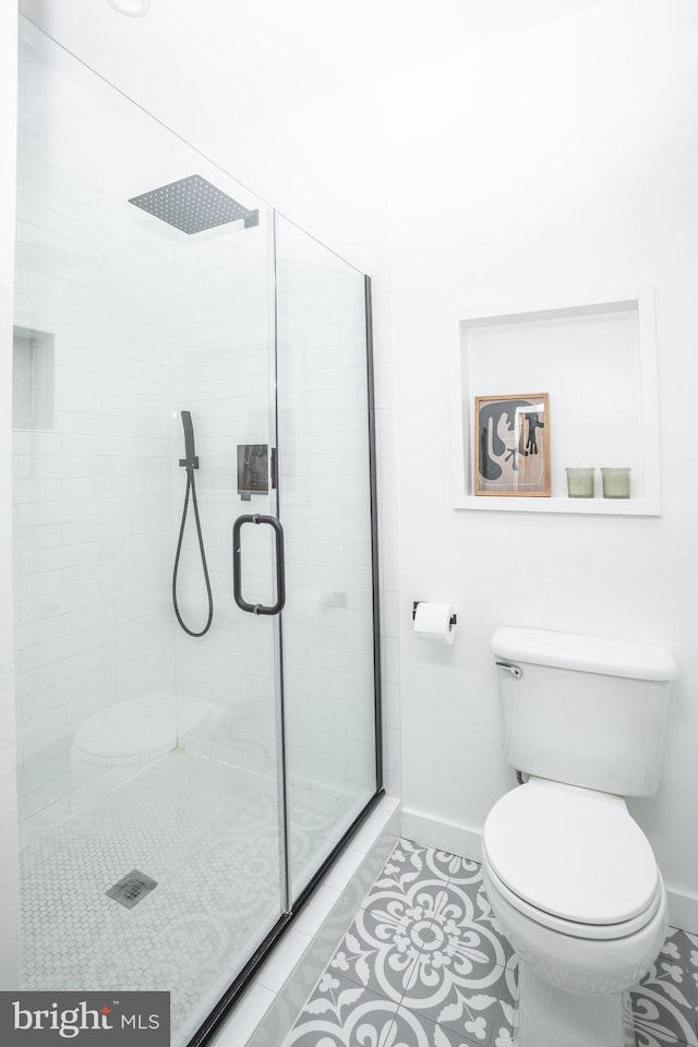 bathroom featuring tile patterned floors, walk in shower, and toilet