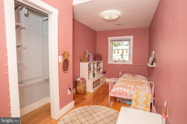 bedroom featuring hardwood / wood-style flooring, a closet, and a walk in closet