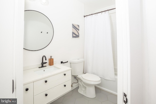 bathroom featuring vanity, tile patterned flooring, and toilet