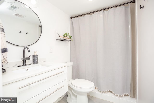 bathroom with vanity, tile patterned flooring, toilet, and curtained shower