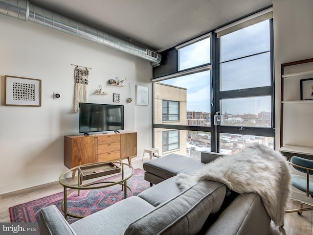 living room with hardwood / wood-style flooring and a wealth of natural light